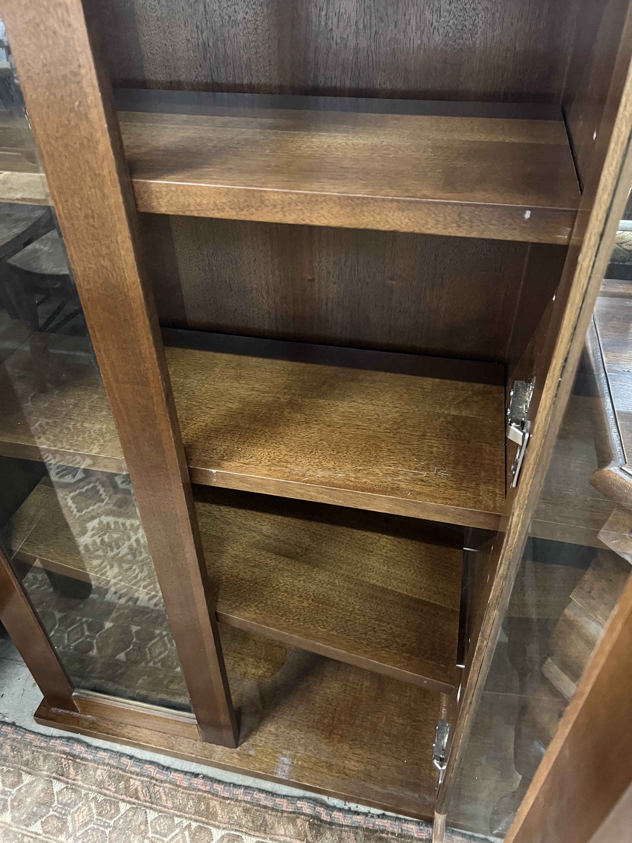 A South African mahogany glazed two door bookcase, width 75cm, depth 35cm, height 135cm